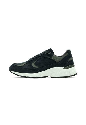 Black and dark green suede sneaker with a padded collar, textured overlays, flat laces, and a white, cushioned midsole. Rubber outsole for grip.