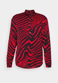 Maglietta a maniche lunghe nera e rossa con motivo a strisce zebra, chiusura con bottoni, collo con risvolto e vestibilità comoda. Tessuto dalla texture morbida.