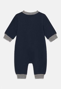 Navyblauer Baumwoll-Overall mit langen Ärmeln, ausgestattet mit gestreiften Bündchen und Kragen. Glatte Textur mit einem Drop-Seat-Design für einfaches Wickeln.
