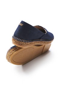 Navy fabric espadrille with a woven jute sole and rubber outsole. Features a smooth texture and stitched accents along the edge.