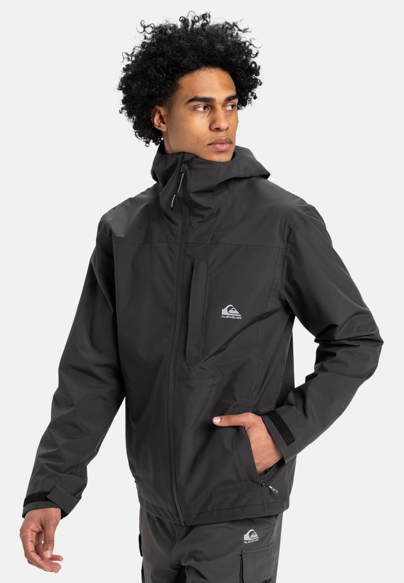 Black waterproof jacket featuring a hood, front zipper, and chest pocket. Notable logo on the left side and adjustable cuffs.