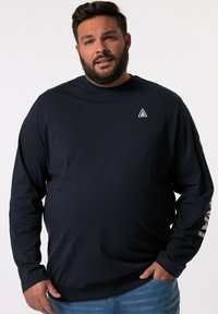T-shirt a maniche lunghe blu navy realizzato in cotone, con un piccolo logo sul petto e un design testuale lungo la manica sinistra.
