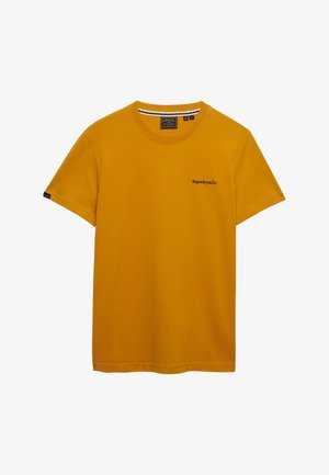 Mosterdgele T-shirt met korte mouwen en ronde hals, met een klein "Superdry&Co" logo op de linkerborst en een label op de linkermouw.