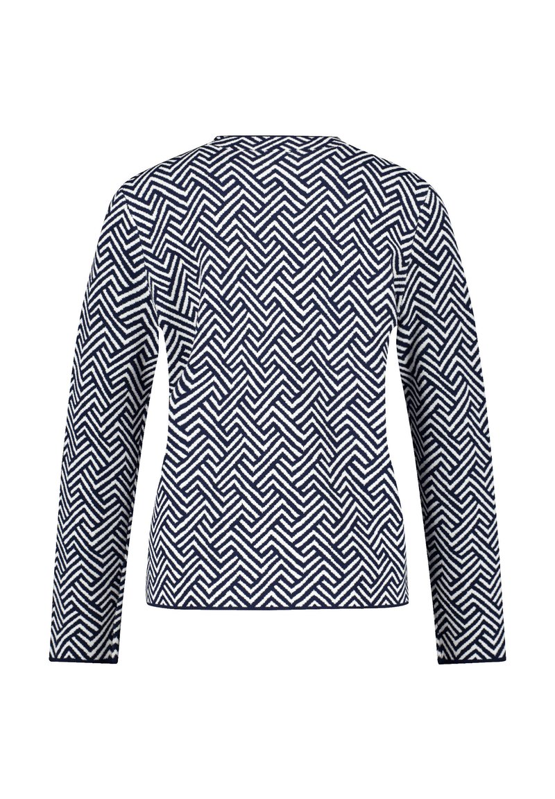 Top de punto de manga larga con un patrón geométrico en zigzag en azul marino y blanco. Cuello redondo y un corte relajado. Textura suave.