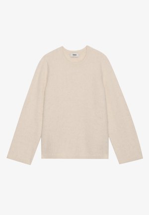 Maglione beige chiaro a maniche lunghe realizzato in materiale morbido. Presenta un collo rotondo e una vestibilità ampia con polsini e orlo a costine.