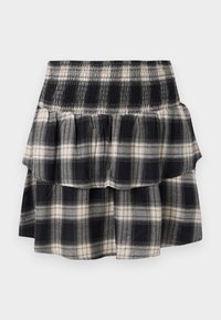 Black and white plaid tiered skirt with smocked waistband. Features ruffled layers and a soft cotton texture.