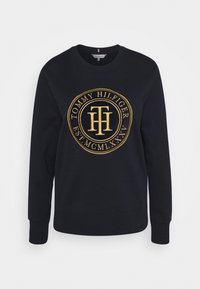 Felpa nera in cotone, con scollatura rotonda, maniche lunghe e un grande logo ricamato dorato sulla parte anteriore.