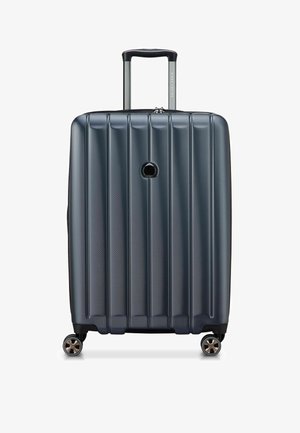 Harde koffer met spinner-wielen in donkergrijs. Bevat verticale ribbels, een uitschuifbare handgreep en vier wielen met chroomaccenten. Met ritssluiting.