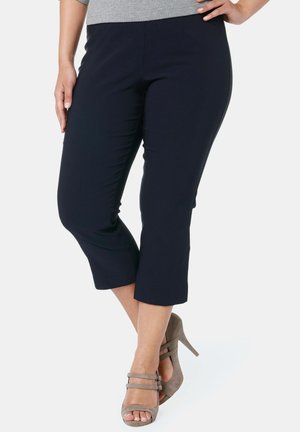 Navy cropped broek van zachte stof, met een gladde textuur en een rechte snit, gecombineerd met grijze hoge hakken.