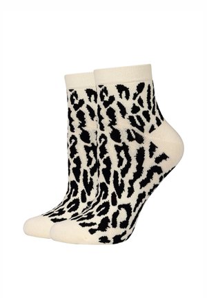 Paar knöchellange Socken mit schwarz-weißem Leopardenmuster auf cremefarbenem Hintergrund.