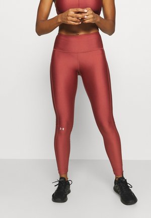 Leggings taille haute, ajustés et moulants dans une couleur rose mat. Tissu lisse et extensible avec des coutures ton sur ton et logo Under Armour en blanc.