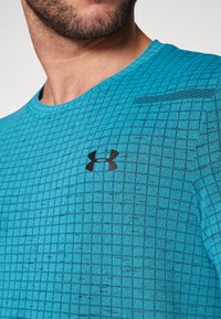 Under Armour VANISH SEAMLESS GRID - Sportovní tričko - circuit teal/black
