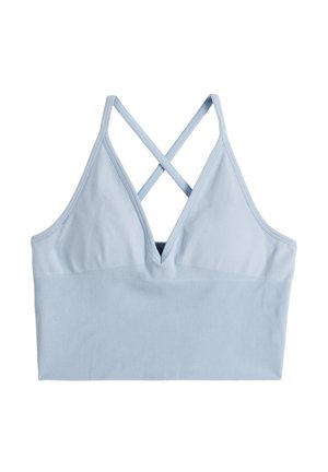 Reggiseno sportivo azzurro chiaro a coste con scollo a V profondo e spalline incrociate sulla schiena su sfondo bianco.