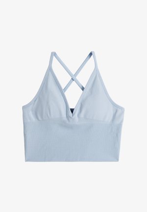 Reggiseno sportivo azzurro chiaro a coste con scollo a V profondo e spalline incrociate sulla schiena su sfondo bianco.