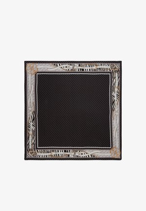 Sottopiatto in tessuto nero con bordi bianco e oro, caratterizzato da motivi a zebra e design intricati. Texture liscia con un contorno dettagliato.