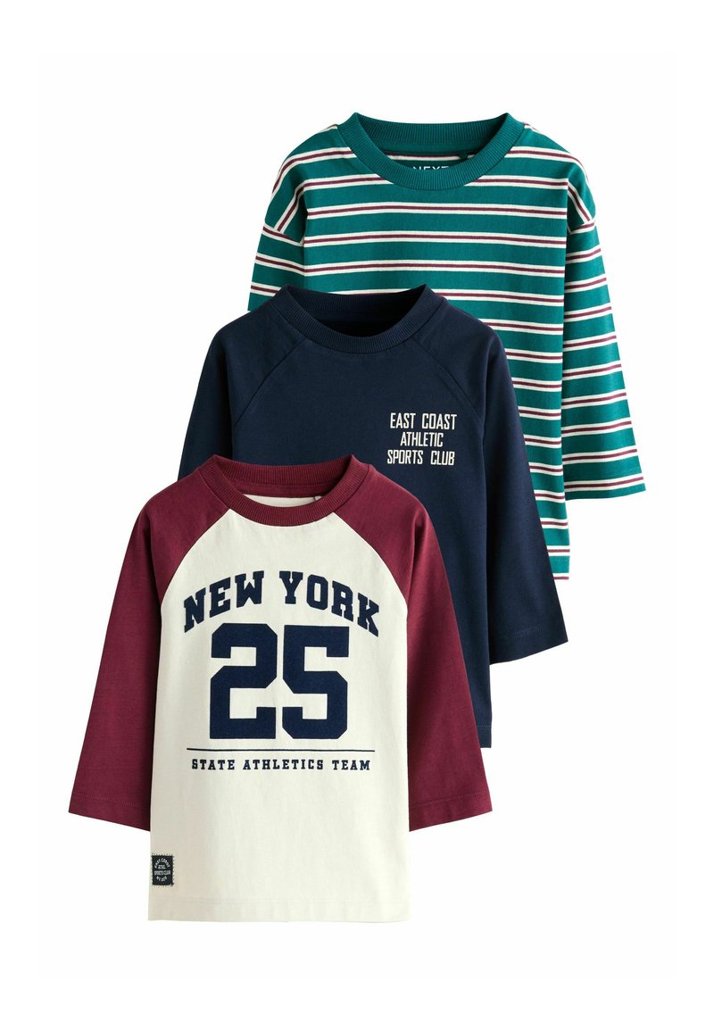 Three long-sleeve shirts: a green striped tee, a navy blue shirt with white text, and a cream shirt with maroon sleeves and bold print.