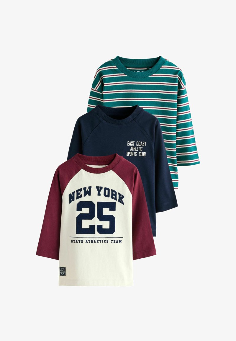 Three long-sleeve shirts: a green striped tee, a navy blue shirt with white text, and a cream shirt with maroon sleeves and bold print.