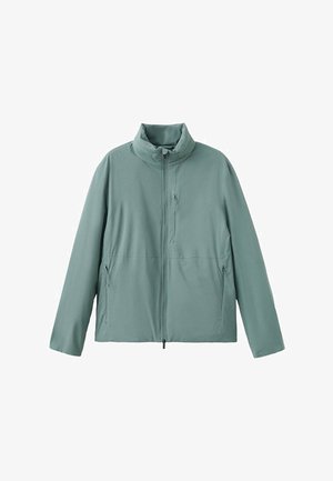 Chaqueta verde claro con cremallera y cuello alto, con tres bolsillos con cremallera, mostrada sobre un fondo blanco.