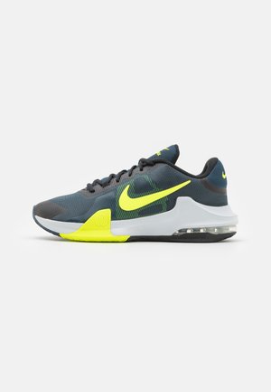 Chaussure de course Nike gris foncé et jaune néon avec talon amorti par air et semelle texturée, présentée de profil sur fond blanc.