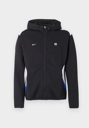 Veste noire à capuche avec fermeture éclair, panneaux latéraux blancs et bleus, logo Nike sur la poitrine gauche, et petit emblème rectangulaire sur la poitrine droite.