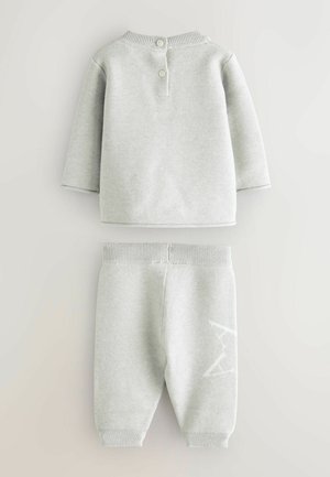 Ensemble pour enfants de couleur gris clair comprenant un haut à manches longues avec un dos boutonné et un pantalon assorti à revers avec un motif d'étoiles.