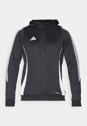 Črna atletska kapuca z belimi stranskimi akcenti, z zadrgo na ovratniku, dolgimi rokavi in logotipom Adidas na prsih. Narejena iz lahkega materiala.
