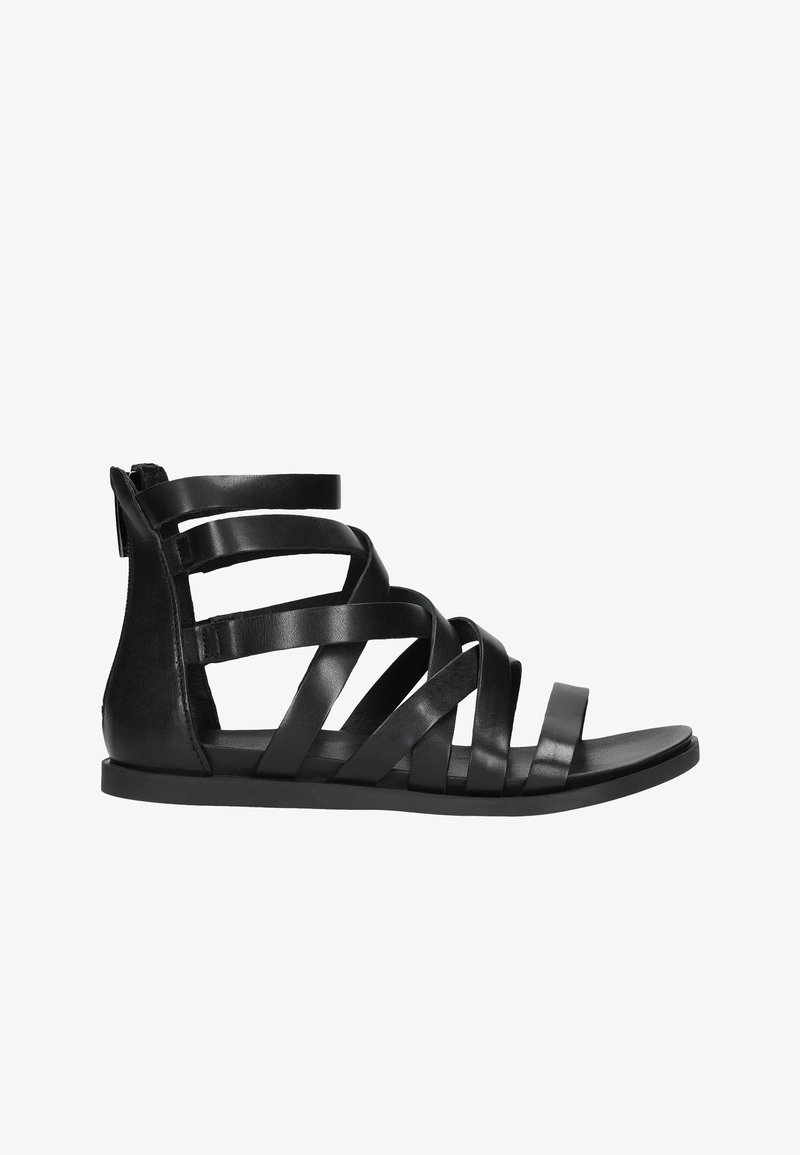 Sandales en cuir noir avec des brides croisées et une semelle plate, dotées de plusieurs brides superposées et d'un support à l'arrière du talon. Texture lisse, design minimal.
