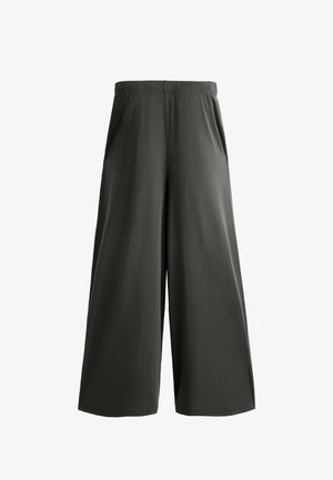 Dunkelgraue, weit geschnittene Culottes mit einem elastischen Bund und einem glatten, leichten Stoff. Sie zeichnen sich durch eine entspannte Passform und keine sichtbaren Taschen aus.
