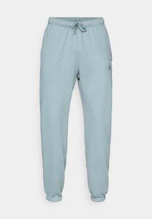 Light blue sweatpants made from soft fabric, featuring an elastic waistband with drawstring, ribbed cuffs, and a small logo on the thigh.
