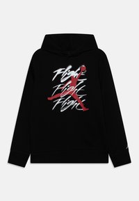 Sudadera con capucha negra que presenta un logo Jumpman rojo y texto estilizado "Flight" en blanco, sobre un fondo de tela negra. Textura sutil.