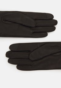 Schwarze Lederhandschuhe mit einer glatten Textur, die ein klassisches Design und gerade geschnittene Finger aufweisen, flach auf einem weißen Hintergrund ausgelegt.