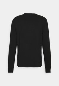 Felpa nera a maniche lunghe con scollatura rotonda, polsini e orlo elasticizzati. Tessuto liscio senza pattern o dettagli hardware visibili.