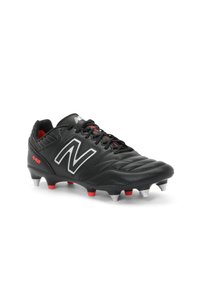 Black soccer cleat made of leather with textured pattern, featuring a silver "N" logo, red accents, and white studs on the sole.