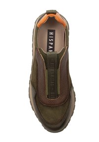 Green slip-on sneaker with brown leather accents, textured panels, and a rubber sole. Features a pull tab and branded elastic strap.