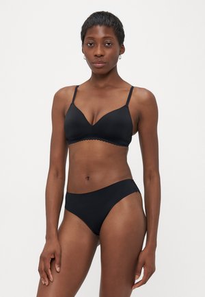 Black lingerie set featuring a molded bra with adjustable straps and scalloped edges, paired with high-waisted, seamless panties.