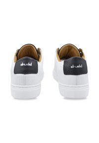White leather sneakers with black heel accents and gold lining. Textured material, round toe, and a subtle logo on the heel.