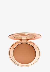 Compact with medium brown pressed powder and rose gold metallic case, lid open showing product and inner mirror.