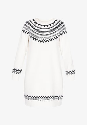 Gebreide sweaterjurk in het wit met zwarte geometrische patronen bij de schouder en manchetten. Heeft een ronde hals en lange mouwen.