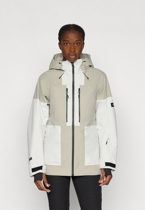 Viegls, ūdensizturīgs jakas beidzis smilšu un baltā krāsā, ar kapuci, priekšējo rāvējslēdzēju, vairākiem kabatām un melniem akcentiem.