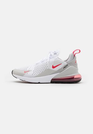 Nike Air Max sneaker featuring a white mesh upper with grey accents, a pink heel air unit, and a prominent red Swoosh logo.