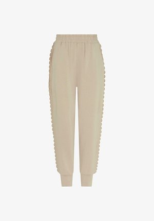 Beige Jogginghosen aus weichem Stoff mit gezacktem Seitendetail. Elastischer Bund und Bündchen für eine entspannte Passform.