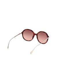 Occhiali da sole tartarugati con lenti rosa sfumate, montatura rotonda e sottili bracci metallici. Presentano un logo discreto sul braccio.