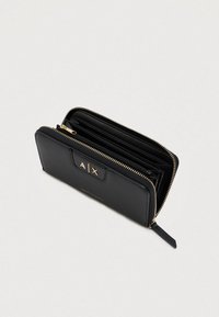 Black zip-around wallet with gold-tone A|X logo, multiple compartments, and a leather zipper pull on a light background.