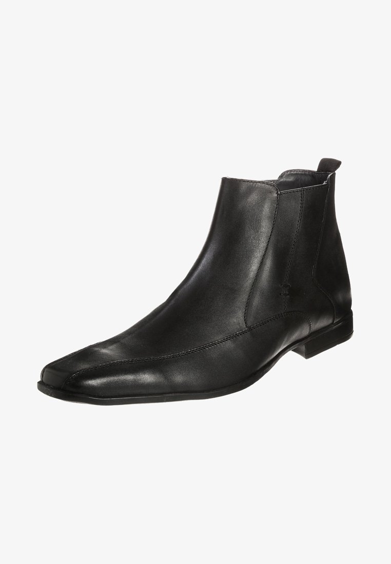 Bottine en cuir noir avec bout pointu, panneau élastique latéral et talon bas, présentée sur un fond blanc.