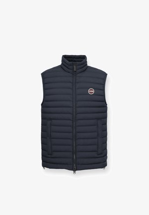 Laivansinis puffer-liivi korkean kauluksen, vetoketjusuljin, vaakasuoran tikkauksen, sivutaskujen ja vasemmassa rinnassa olevan logopatchin kanssa.