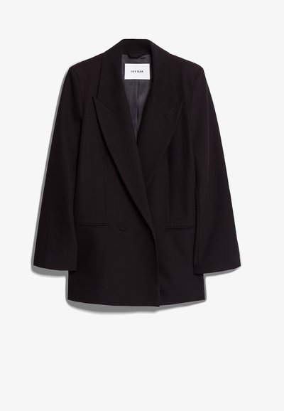 Μαύρο σακάκι διπλής όψης φτιαγμένο από λείο ύφασμα, με φαρδιές πέτες, δύο μπροστινές τσέπες και προσαρμοσμένη σιλουέτα. Ετικέτα μάρκας ορατή στο εσωτερικό.
