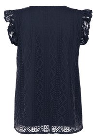 Top sans manches bleu marine avec un tissu texturé à motif en losange complexe et des manches à volants bordées de dentelle. Doté d'un ourlet ouvert.