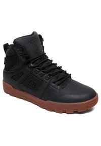 Black high-top sneaker featuring a smooth leather upper, fabric accents, rubber sole, textured lace system, and logo detail on the side.