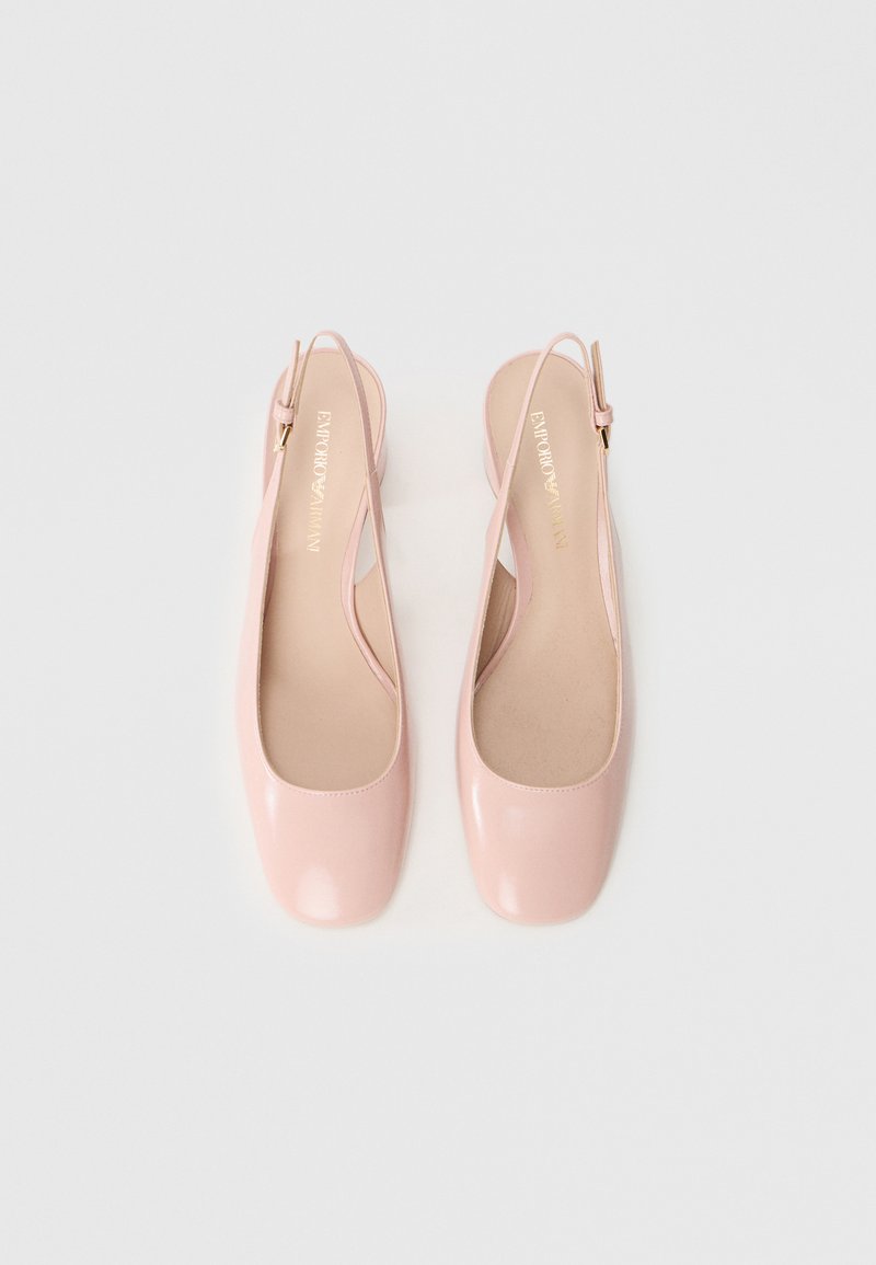 Różowe lakierowane baleriny z odkrytą piętą, o zaokrąglonym nosku, minimalistycznym wzornictwie i złotych akcentach na regulowanym pasku. Gładka tekstura.
