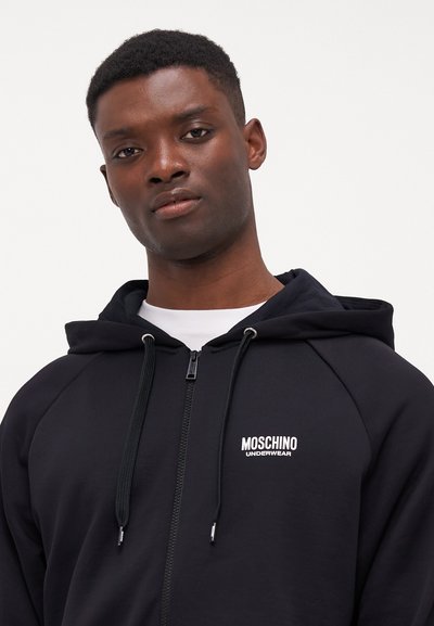 Black hoodie with zip closure, drawstring hood, and raglan sleeves. Features a white "Moschino Underwear" logo on the left chest.